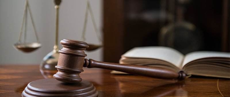 Gavel and scales of justice on a wooden desk
